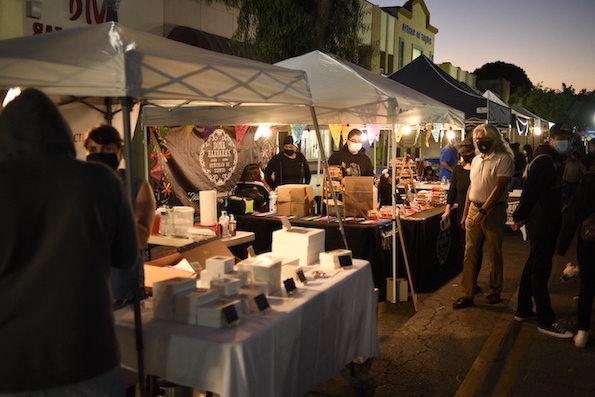 Vendors engage with event attendees as the night rolls in. (Courtesy of Erik Adams. UT.)