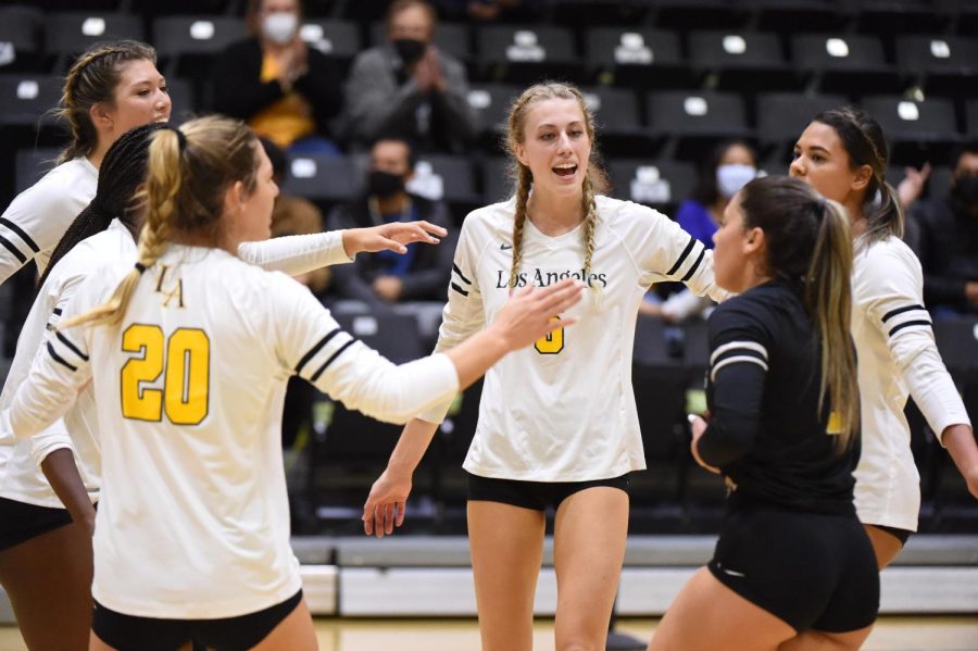 Cal State LA women's volleyball team give themselves a pat on the back.