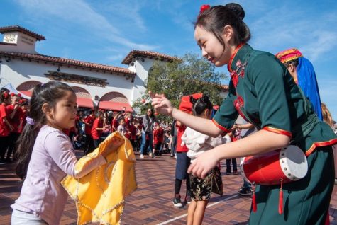 A child and a woman with traditional green clothes