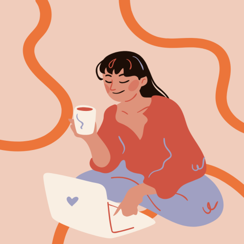A picture of a girl sitting on the floor holding a cup of coffee and smiling at her computer.