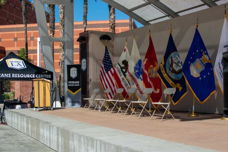 An American flag, California flag and military flags on the stage of the U-SU plaza where the Veterans Ceremony took place.