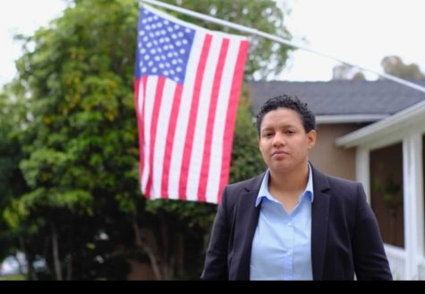 Itzel Barakat, 36, poses infant of an American flag.