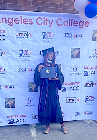 In this photo someone stand up with the Graduation Award and hooded with the academic award