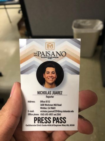 A photo of someone holding a press pass that says "El Paisano"