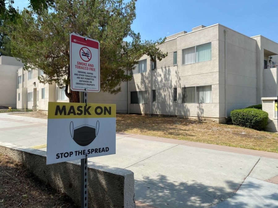 A “Mask On” COVID-19 safety sign outside the Cal State LA student dorms.