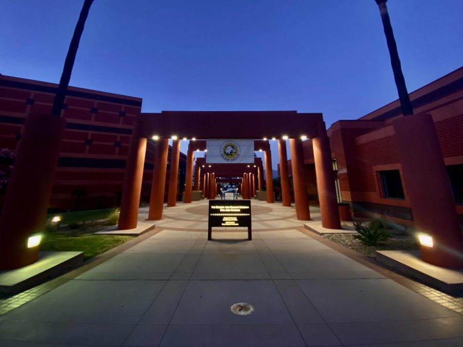 A picture of the main archway on campus in front of the student union at night.