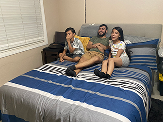 A group of siblings having fun and watching a movie together.