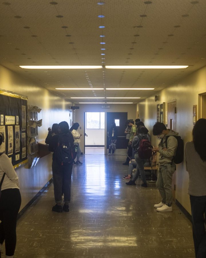 Students standing outside a classroom in King Hall.