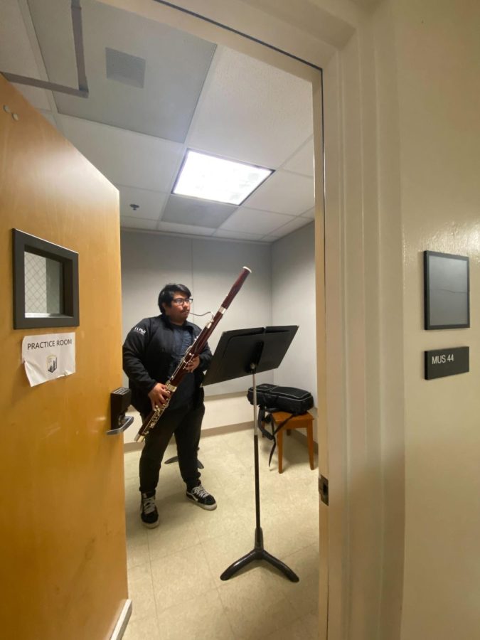 Student musician playing the Bassoon in a private practice room.