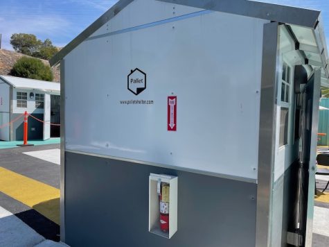 white metallic-looking building, the size of a large storage shed