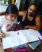 Estrada helping his daughter with her homework.