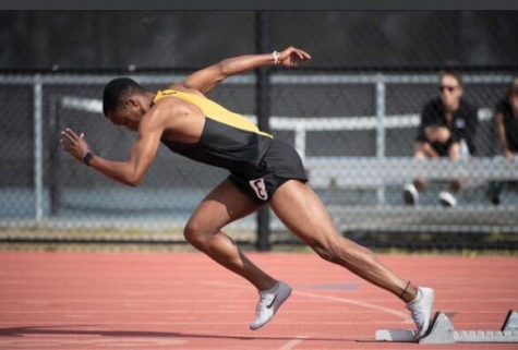 A person in a track uniform during a meet. 