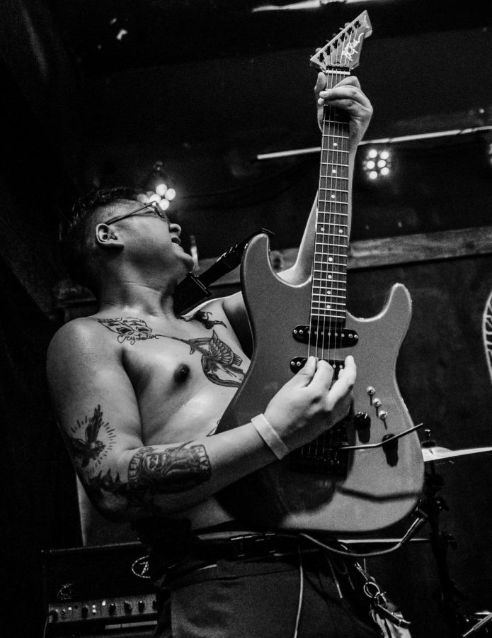 Black+and+White+photo+of+Juan+Lopez+rocking+out+with+his+guitar.