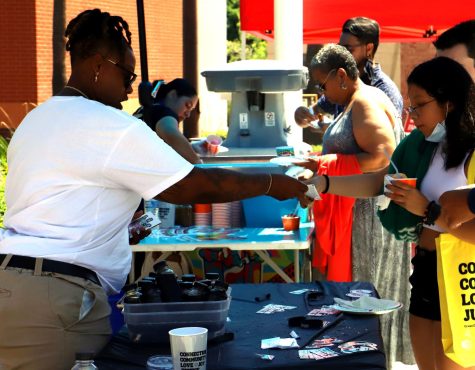 A woman giving food to a customer