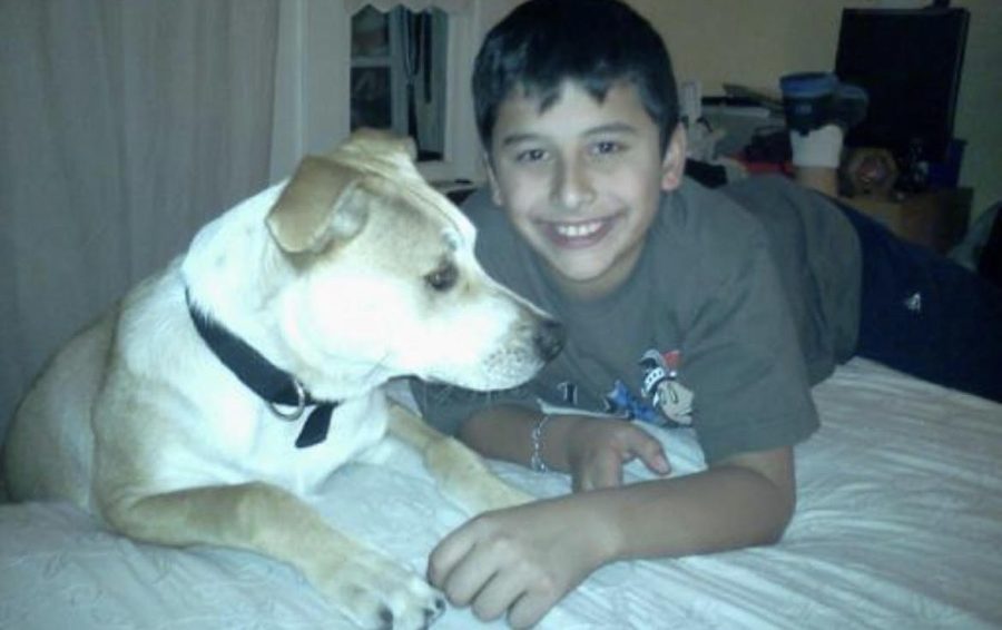 Andres+smiles+with+his+dog+Hunter.
