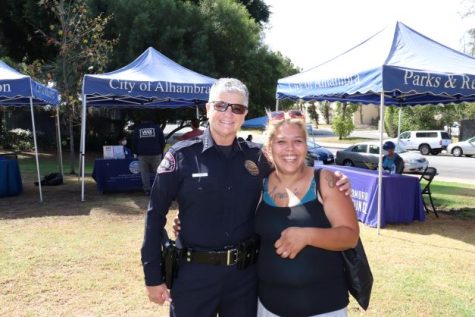 Alhambra Chief of Police poses for picture with a woman.