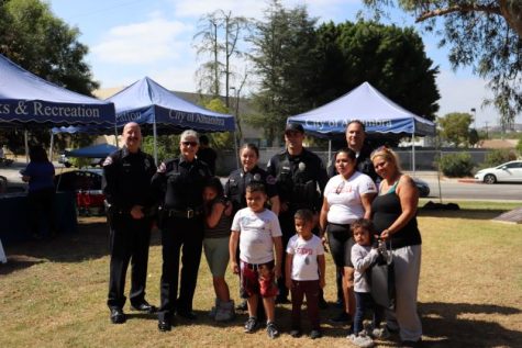 Alhambra Police take pictures alongside a family.