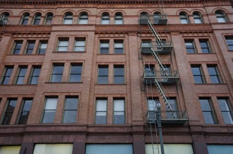 brown brick apartment building with fire escape