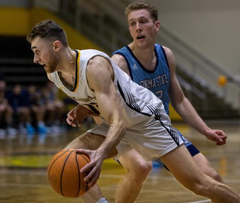 Golden Eagle Alexander Sokol dribbles past the Seawolves Pierce Rexford during their game against Sonoma St. at University Gym on Thursday, Feb. 23, 2023. CSULA would fall to Sonoma St. 70-56. Photo by Xavier Zamora.
