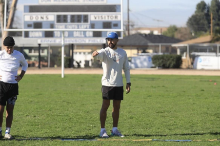 PE Teacher Joshua Pera in a field.