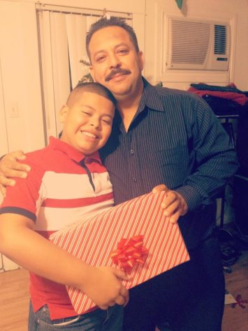 Young Joshua Alvarado taking a photo with his dad.