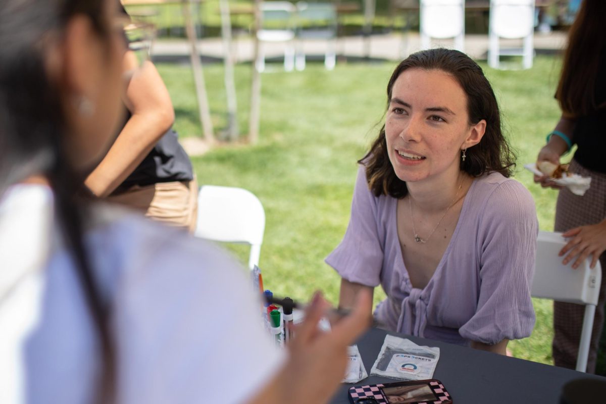 Breck Miner, a student representative of the InterVarsity Christian Fellowship, talks to students at City of Orgs, held on the main campus walkway on Thursday, August 24, 2023. 