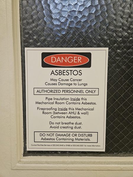Abestos warning sign on door