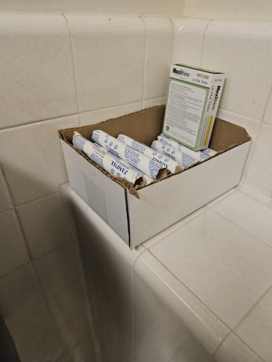 Boxes of menstrual products were placed next to the sink instead of refilling the dispensers in the restroom.