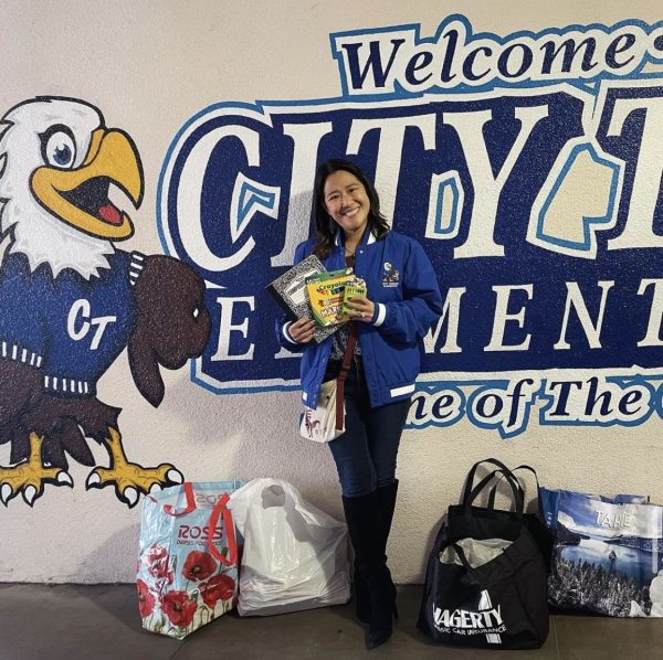 City Terrace Elementary School Principal Elaine Hu shows some of the supplies she recived from the university. (Photo Courtesy of Cal State LA Library Instagram) 