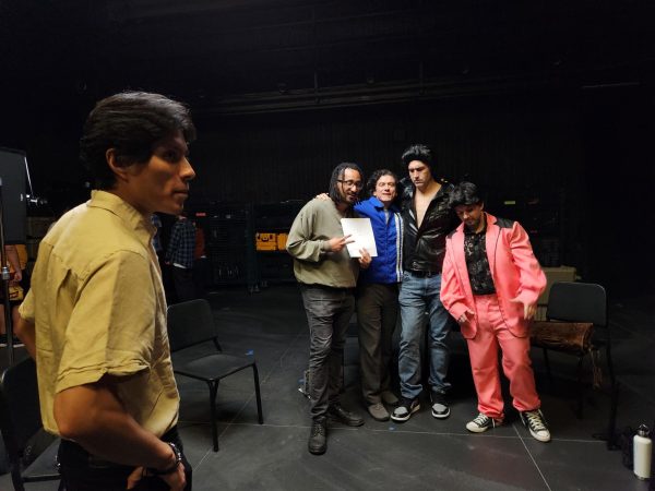 Enecon Tejada, a senior at Cal State LA and director of the The Evils of Elvis, stands by writer Amir Medina, and his cast.