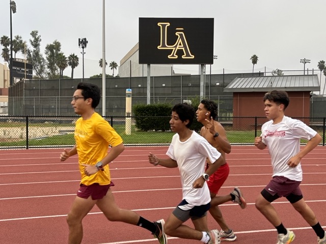 Runners practice at University Stadium on Wednesday, Aug. 28.