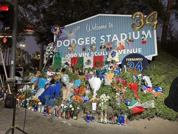 Vigil lined with flowers and candles memorializing Fernando Valenzuela in front of the Dodger Stadium on Vin Scully Avenue on Oct. 24, 2024. 