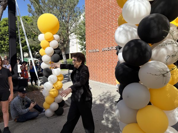 Billie Jean King walks out from the gymnasium to a crowd awaiting her speech during a ceremony on Wednesday, Oct. 2, 2024.