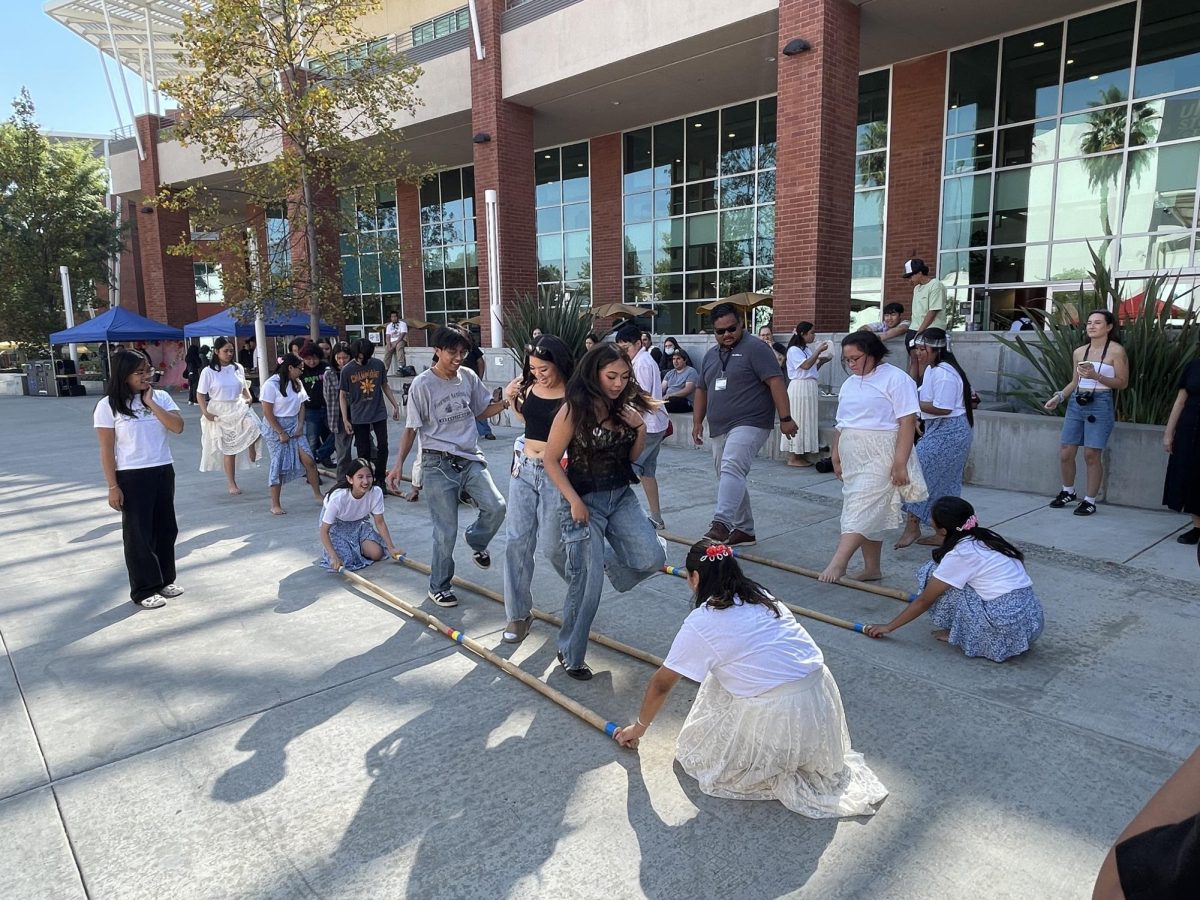 Students and attendees join in on the Tinikling dance at the Filipino American History Month celebration on Thursday, Oct. 24, 2024.