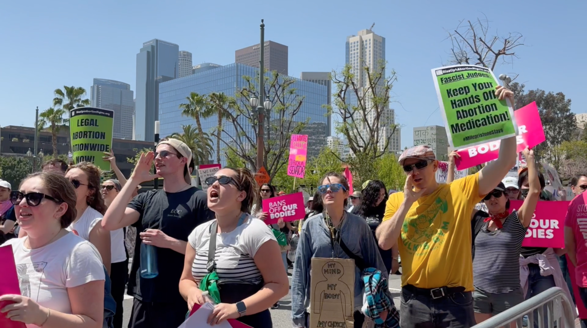 Protesters hold signs and chant "no justice, no peace" at the Women's March in front of Los Angeles City Hall on Saturday, April 15, 2023. The march was organized after a federal judge in Texas blocked the FDA approval of the abortion drug Mifepristone.