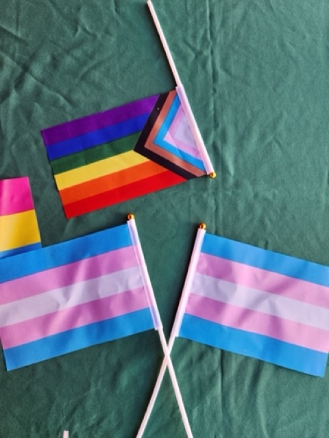 Transgender and Progress Pride flags on a table at the Cal State LA National Coming Out Day event on Oct. 10, 2024.