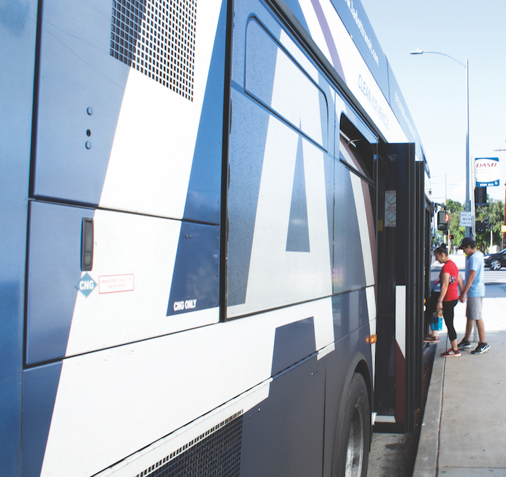 A mother and son board the DASH bus to take a trip through the neighborhood. Photo by Jorge Garcia