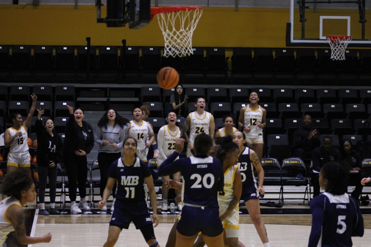 Golden Eagles cheer from the sidelines after Brooklyn Giles makes a basket during the match against Cal State Monterey Bay on Saturday, Dec. 7 at University Gym. The Golden Eagles won 76-45.