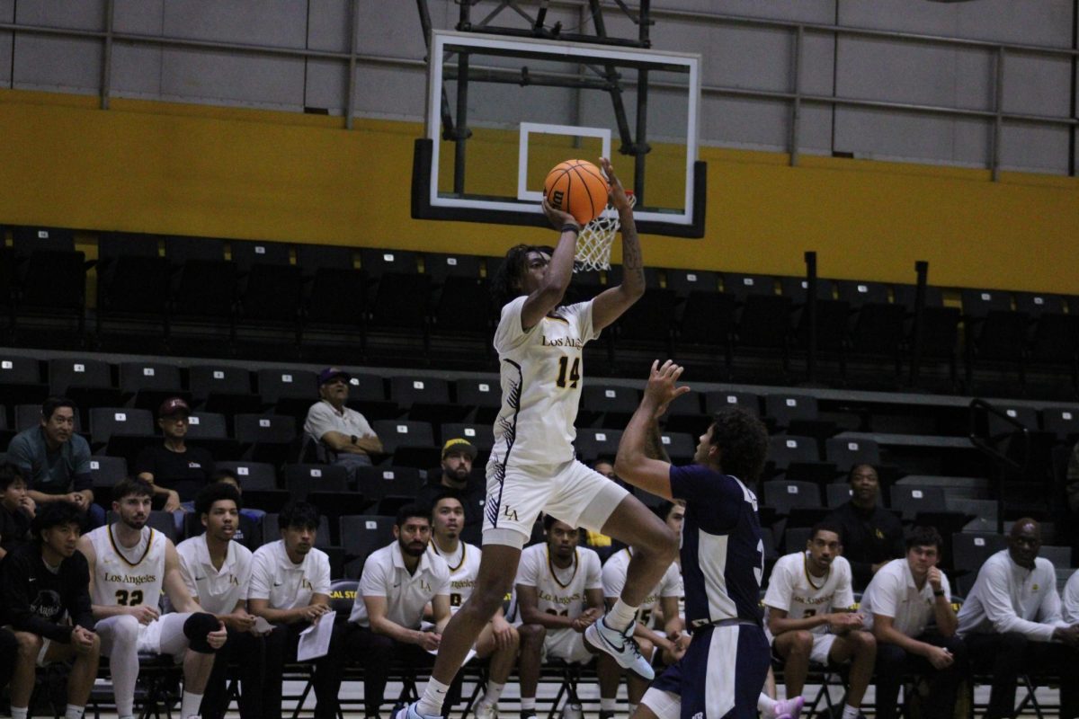 Shane Bell lines up the shot during the Golden Eagles' match against Cal State Monterey Bay on Saturday, Dec. 7 at University Gym. The Golden Eagles won 64-45.