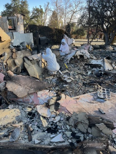 The Goodman family look through the ruins of their destroyed home in Altadena on Monday, Jan 20. Photo courtesy of the Goodman family.