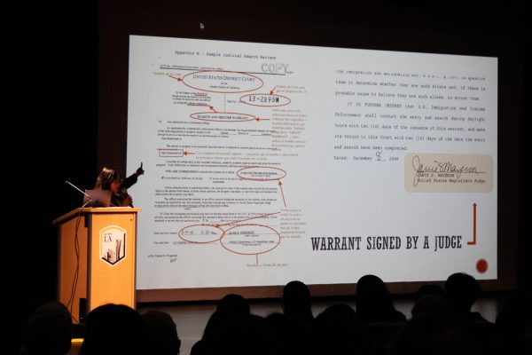 Immigration lawyer Lisbeth Mateo instructs the crowd on how to differentiate between warrants that ICE officials may show to people during a panel on Thursday, Feb. 27, 2025. Photo by Jackson Tammariello.