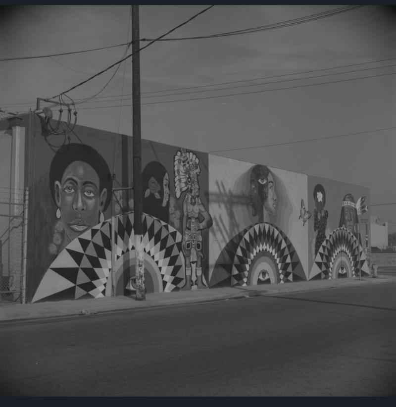 Mural designed by Elliott Pinkney featuring three large panels painted with women’s faces / Photo courtesy of the Cal State LA Digital Archive