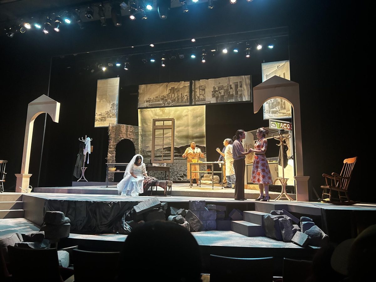 Four families on stage as the light switches to each family and their story between traditions, heritage, and culture__