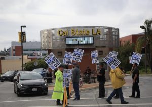 Picketers from the Teamsters Local 2010 and allies march in front of the Cal State LA Welcome Center on day one of the four day strike. 