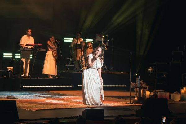 Backed by her live band, Chiquis moves across the stage in a flowing white dress, tuning into the intimacy of the performance.